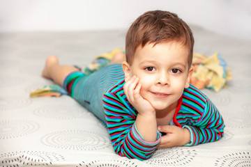 Portrait little boy on bed