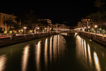 Fototapeta na wymiar Night river channel of Rapallo town, Liguria, Italy