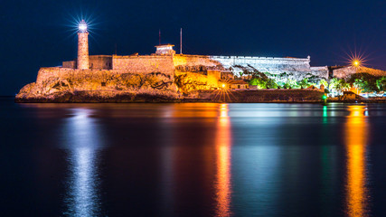 Fototapeta na wymiar Havana, Cuba. Lighthouse and Morro Castle mirroring in the Caribbean Sea.