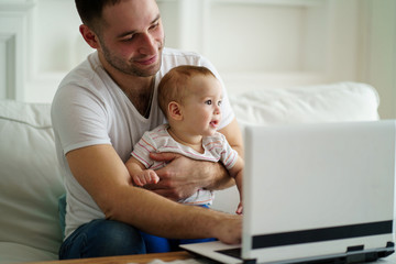 lifestyle of modern business father. young man babysitting working overtime at home office. daily...