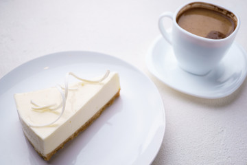 New York cheesecake and cup of coffee on white background. traditional recipe, sweet food, confectionery