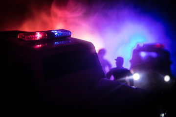 Police car chasing a car at night with fog background. 911 Emergency response police car speeding to scene of crime. Selective focus © zef art
