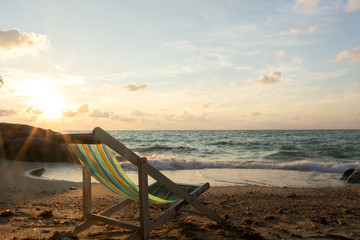 Summer vacation deckchairs on tropical beach and ocean sea at sunrise background. Travel and vacation holiday.