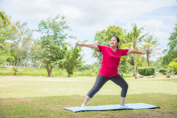 Portrait of asian aged women doing yoga exercise in park