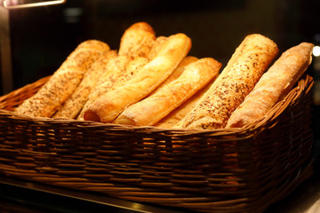basket with bread sticks on bakery counter
