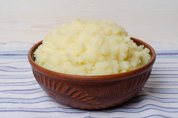 Mashed potatoes in a clay bowl.