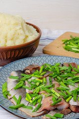 Herring fillet with green onions with mashed potatoes.
