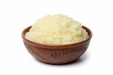 Mashed potatoes in a clay bowl. Isolate.