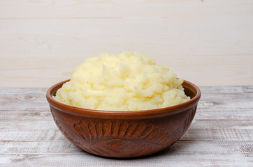 Mashed potatoes in a clay bowl.