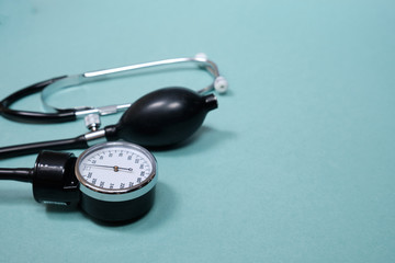 phonendoscope and tonometer  with pills   on a blue background. Copy space