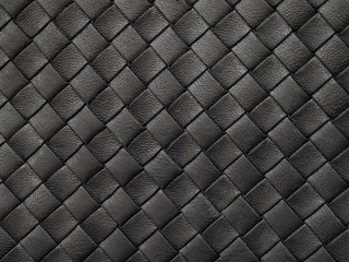 Braided texture of old black leather. Close up. 