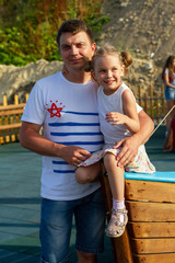 Fototapeta premium Father and daughter have fun together at the playground in the summer.