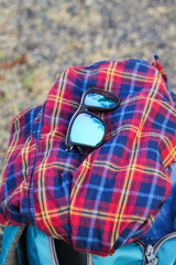 sun glass over the shirt and a bag