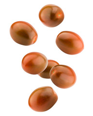 Falling kumato black tomato, cherry, isolated on white background, clipping path, full depth of field