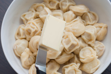 Add butter on a knife to the dumplings on a white plate for better digestibility