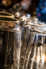 Transparent glasses and cups dry and warmed up on the coffee machine. Coffee shop. Background.