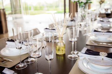 Arranging cup of dishes on table.