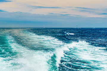 Naklejka na ściany i meble Sea water foam Ship track in the ocean Water texture. Ocean view Marine travel Cape cod Massachusetts
