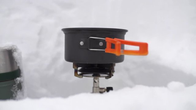 Melting Snow for Water in the Snow Covered Winter Backcountry Mess Kit Pot on Burner Ski Adventure USA Super Slow Motion HD 240fps