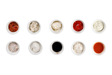 Cups with a variety of sauces on a white background.