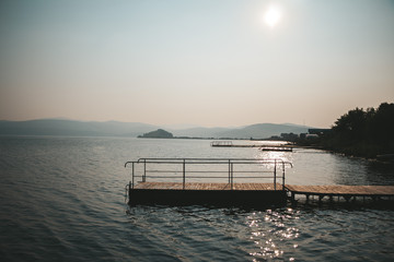 Fototapeta premium Piers along the coast in the setting sun