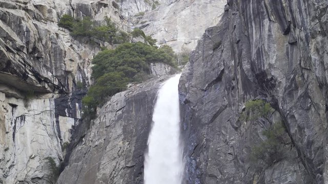 Top of a waterfall in Yosemite National Park cascading over granite cliff