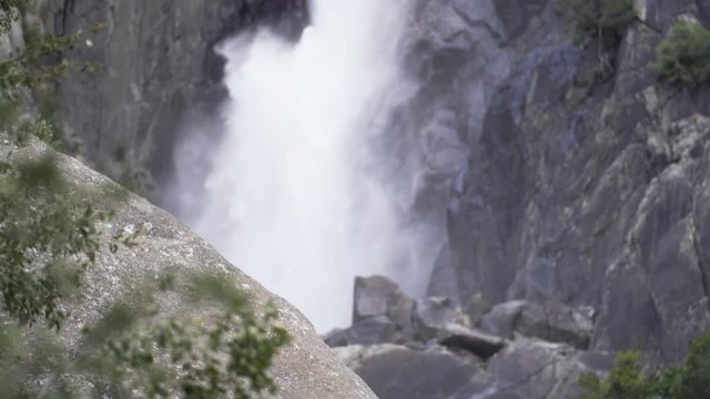 Pan up to rack focus on waterfall in Yosemite National Park
