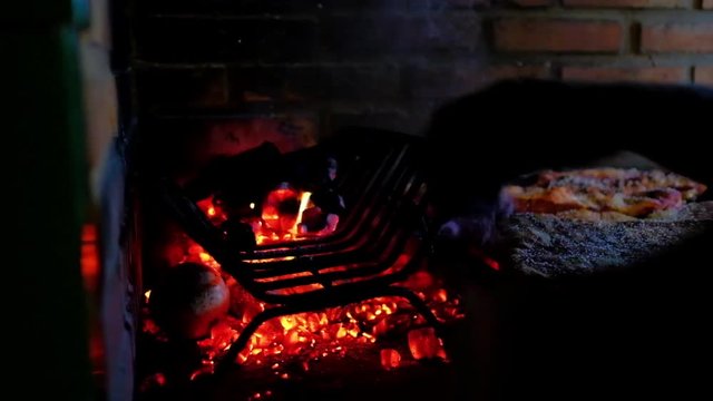 Typical and authentic Argentinian Barbecue Or Asado. Burning Wood In The Grill And Red Hot Coals