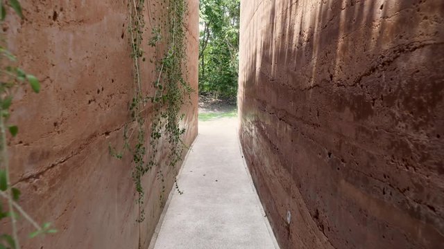 Walkway between stone walls