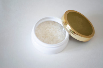 bath salt crystals in a white jar on a light background