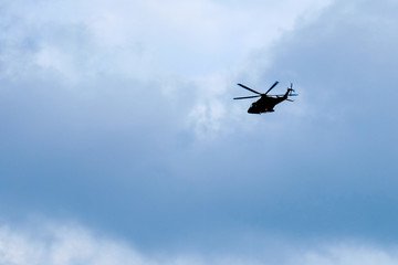 Fototapeta na wymiar Flight of the helicopter,on sky background
