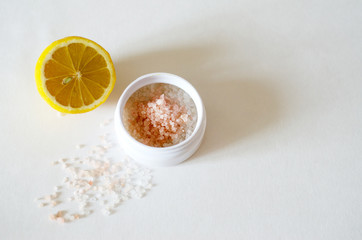 bath salt crystals in a white jar on a light background