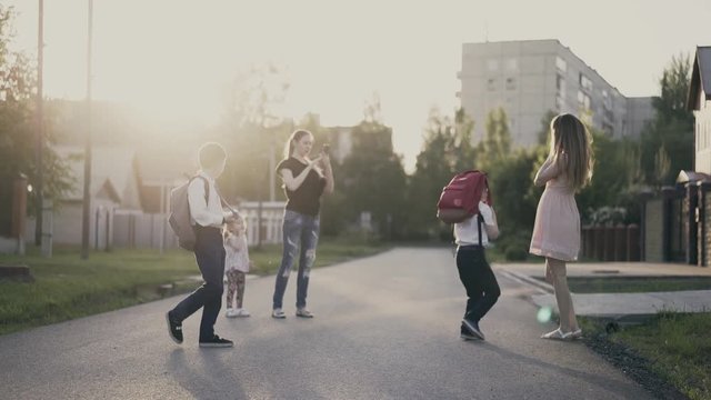 Students with their mothers are photographed in courtyard, after school hours.