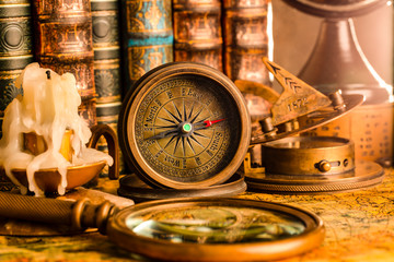 Antique compass on the background of the globe and books. Vintage style. 1565 old map of the year.
