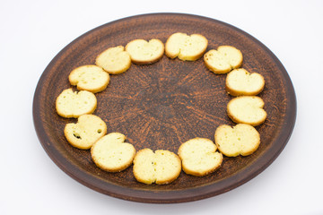 Bake Rolls. The mini bread chips on the brown bowl. Isolated on white background.