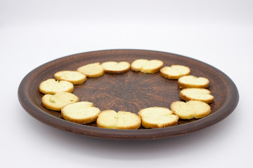Bake Rolls. The mini bread chips on the brown bowl. Isolated on white background.
