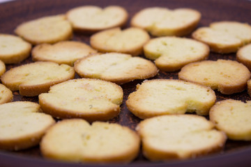 Bake Rolls. The mini bread chips on the brown bowl. Isolated on white background.