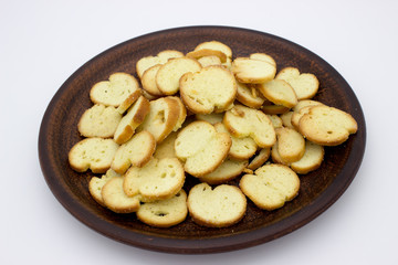 Bake Rolls. The mini bread chips on the brown bowl. Isolated on white background.