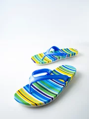 Tuinposter Colorful striped flip flops on white background © jittima