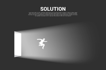 Obraz na płótnie Canvas Silhouette of businessman jump out from the door of light. Concept of business direction and solution.