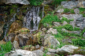 Flowing water stream, water drops and reflection
