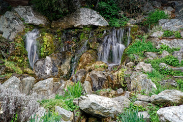 Flowing water stream, water drops and reflection