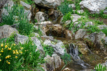 Flowing water stream, water drops and reflection
