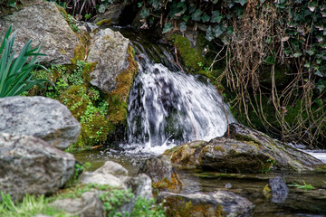 Flowing water stream, water drops and reflection