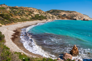Aerial view of blue lagoon. Beautiful seascape. Waves on a pebble beach. Petra tou Romiou...