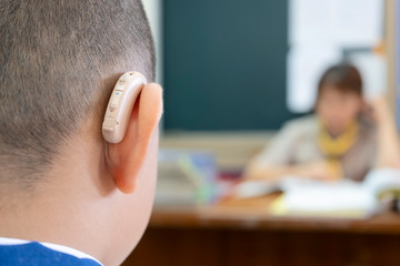 Students who wear hearing aids to increase hearing efficiency.