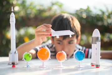 Little boy playing space ship and planet galaxy toy