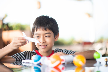 Little boy playing space ship and planet galaxy toy