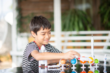 Little boy playing space ship and planet galaxy toy
