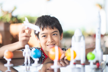Little boy playing space ship and planet galaxy toy